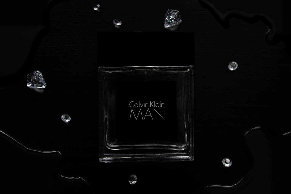 A man smiling while holding a premium beard grooming kit.