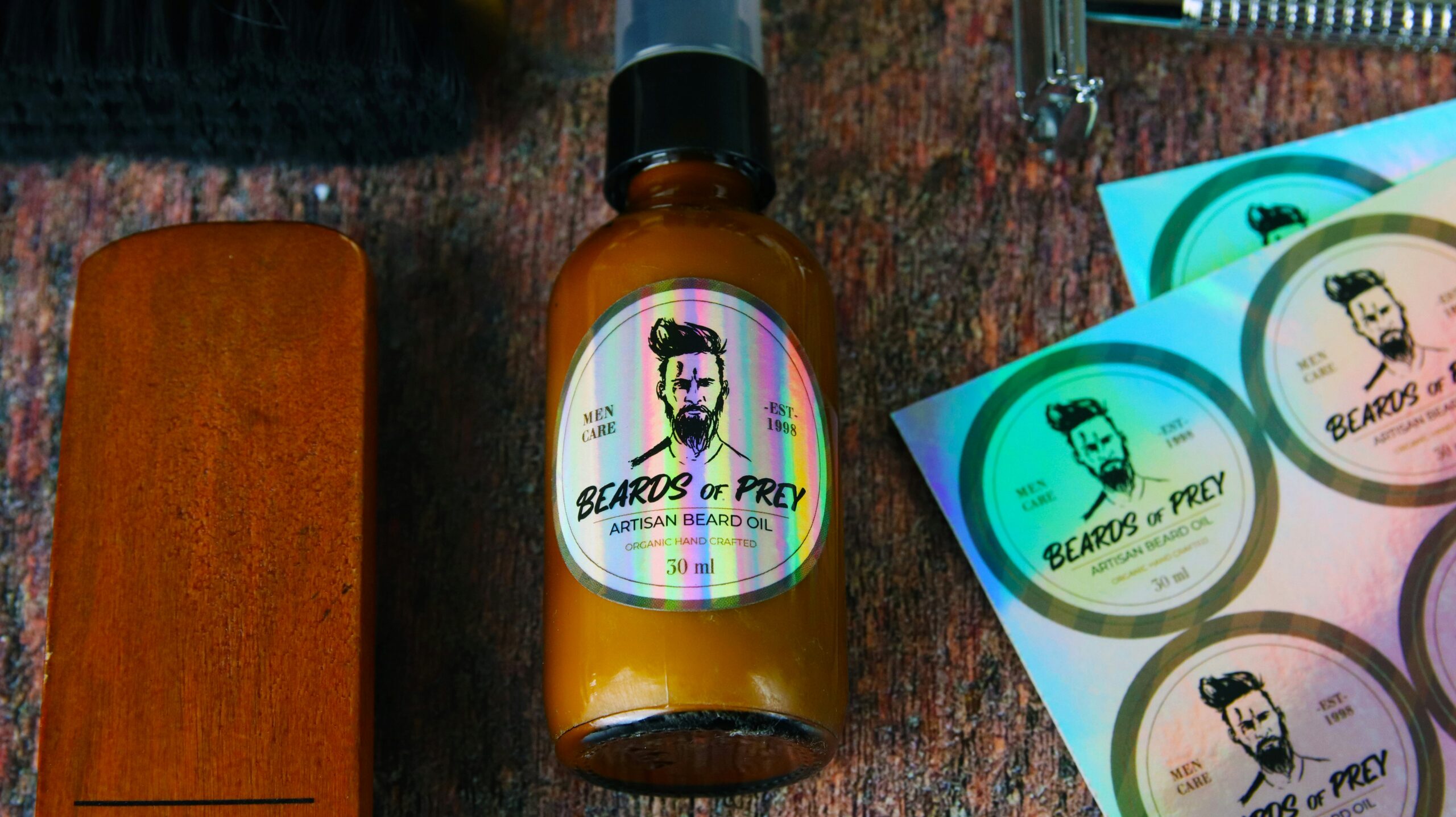 Circle holographic labels applied to an amber jar containing beard oil