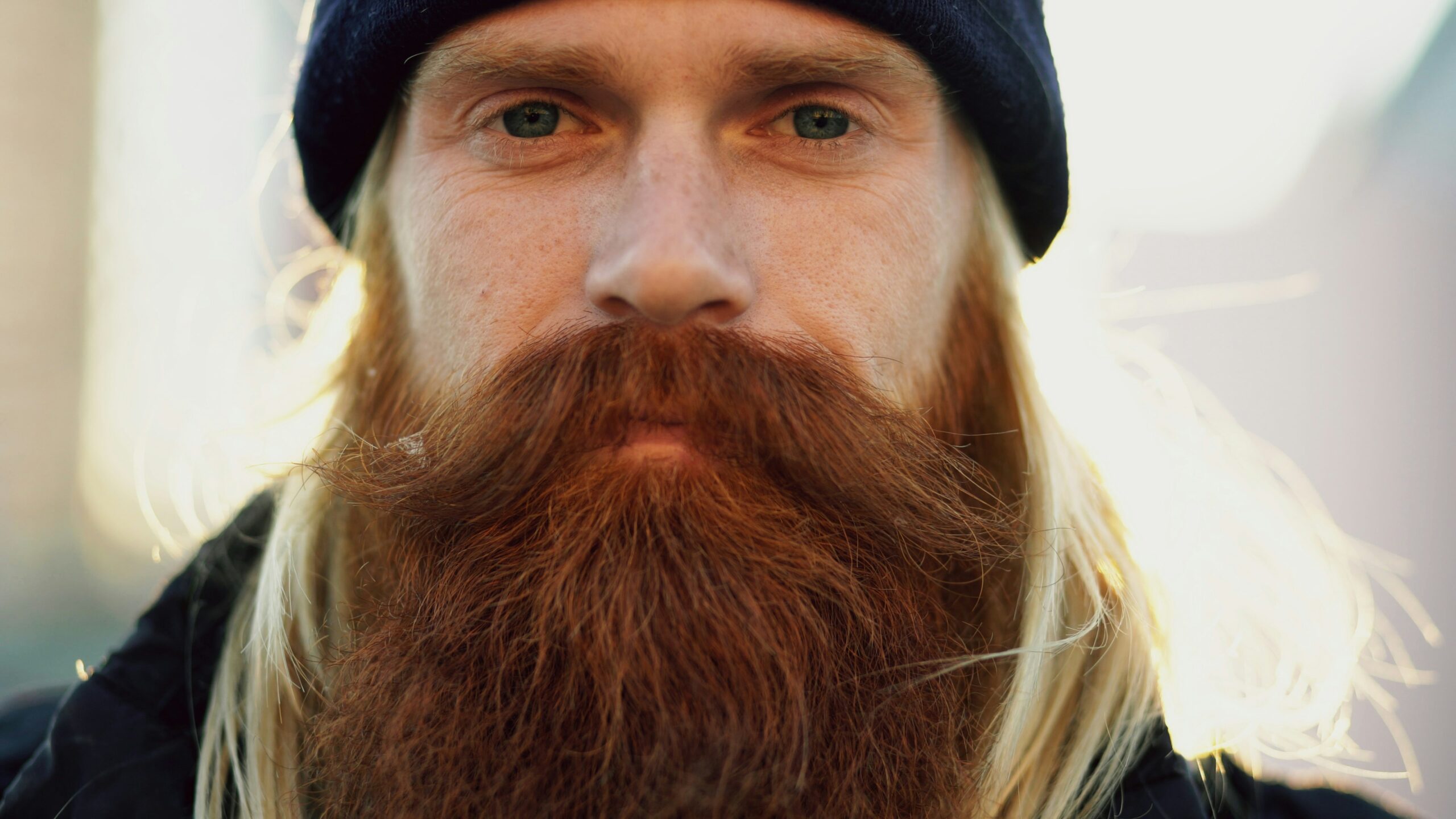Closup portrait of bearded hipster and hard worker man looking at camera with serios face