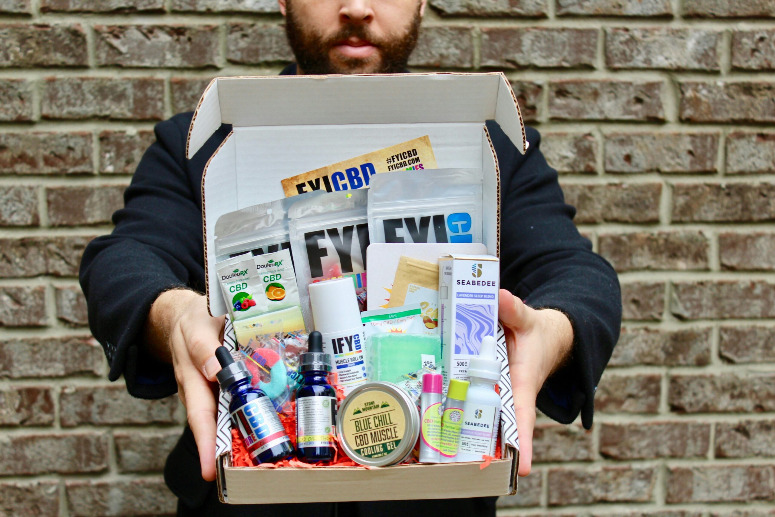 man holding white and blue plastic pack