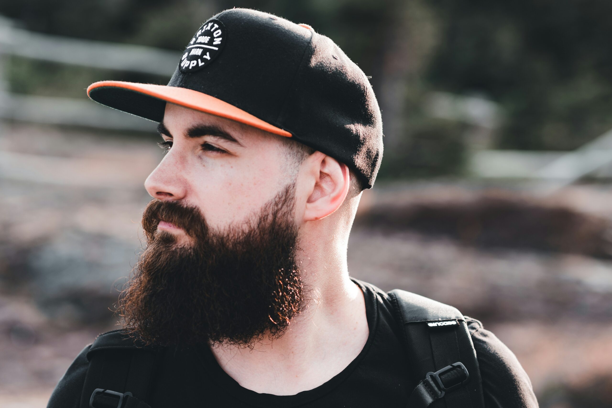man in black and white fitted cap