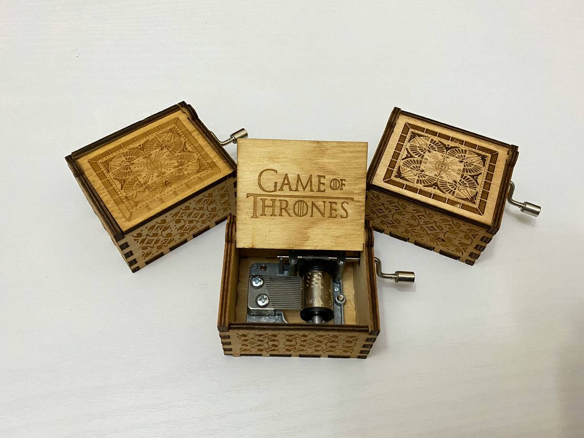 A high-quality beard care gift package featuring oil, balm, scissors, brush, and comb displayed on rustic wood background.