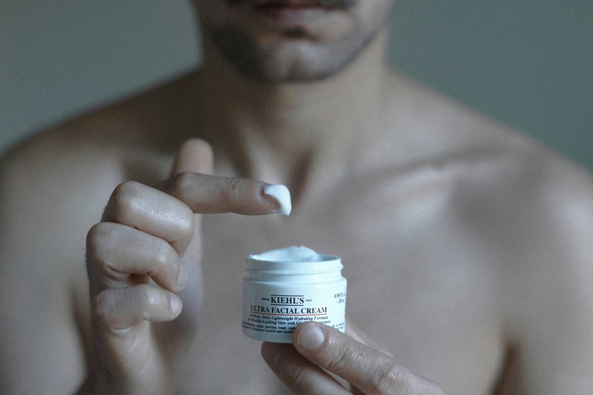 Man holding a premium beard cleansing kit with products neatly arranged