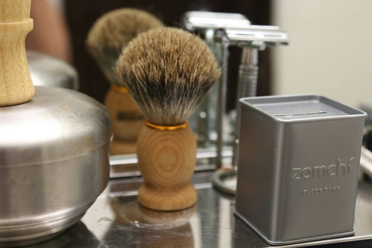 A high-quality leather case containing various beard grooming tools laid out neatly.